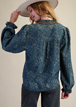 Load image into Gallery viewer, Woman in hat wearing floral denim blouse with beige background