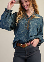 Load image into Gallery viewer, Woman in hat wearing floral denim blouse with beige background