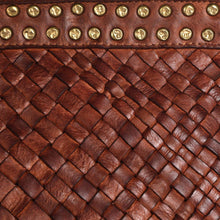 Load image into Gallery viewer, Close-up of a brown leather bag with gold studs