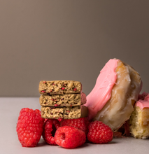 Load image into Gallery viewer, Stack of cookies with pink icing and raspberries on a neutral background