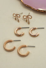 Load image into Gallery viewer, Set of rose gold earrings including bow-shaped and hoop designs on a light background.