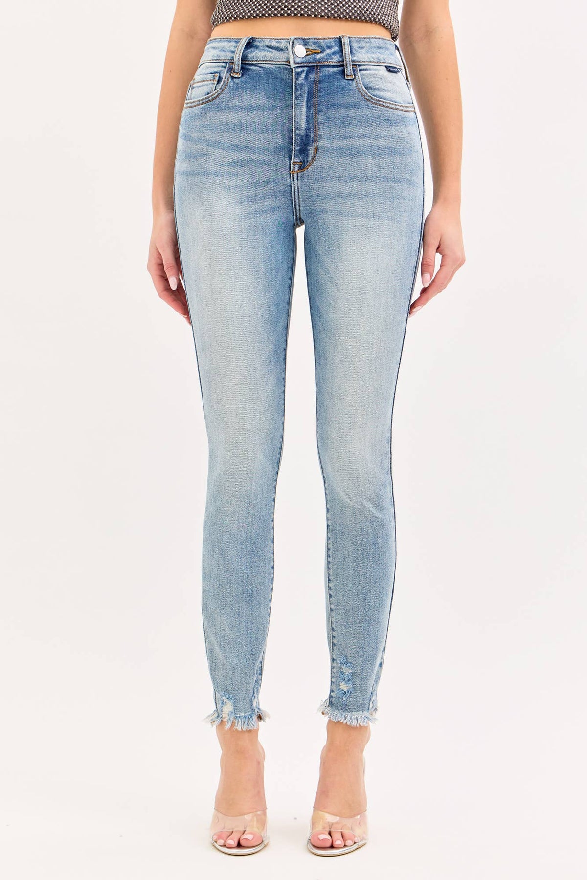 Light blue jeans worn by a person on a white background