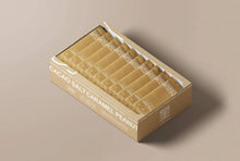 Load image into Gallery viewer, Box of Cacao Salt Caramel Peanut snacks on a beige background
