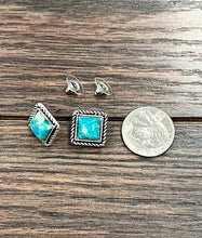 Load image into Gallery viewer, Turquoise stone earrings with silver settings on a wooden surface, next to a quarter for scale.