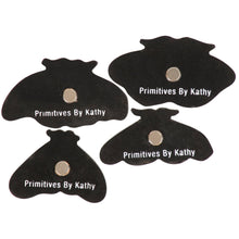 Load image into Gallery viewer, Black butterfly-shaped cutouts with metallic centers labeled 'Primitives By Kathy' on a white background.