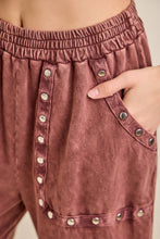 Load image into Gallery viewer, Close-up of pink pants with button details on a neutral background