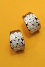 Load image into Gallery viewer, Pair of earrings with floral design on a yellow background