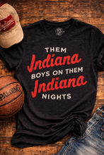 Load image into Gallery viewer, Black t-shirt with red text 'Them Indiana Boys on Them Indiana Nights' on a wooden surface with a cap, basketball, and jeans.