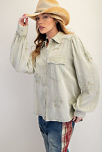 Load image into Gallery viewer, Woman wearing a light-colored shirt with star patterns and a cowboy hat on a plain background