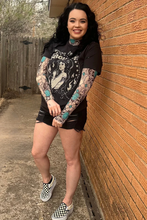 Load image into Gallery viewer, Woman with tattoos leaning against a brick wall