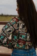 Load image into Gallery viewer, Person wearing a colorful patch jacket with various designs outdoors.