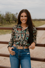 Load image into Gallery viewer, Woman wearing a patterned shirt and jeans standing outdoors.